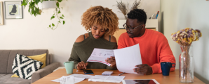 A couple sitting at the table reviewing their bills